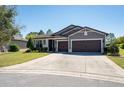 Beautiful single-story home with a well-maintained lawn and a three-car garage at 6898 Sw 95Th Cir, Ocala, FL 34481