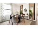 Elegant dining area with modern decor, decorative plants, a large window, and neutral accents at 2276 Red Sun St, Apopka, FL 32703