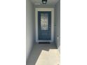 Close-up of the home's decorative front door with glass detailing and sidelights at 4516 Casablanca Ave, Kissimmee, FL 34746