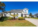 A well landscaped two-story home with a manicured lawn on a sunny day at 622 Copeland Dr, Haines City, FL 33844