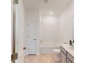 Bright bathroom with a white tub, neutral-toned tile flooring, and a single sink vanity at 815 Middleton St, Debary, FL 32713