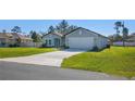 Charming single-story home featuring a well-manicured lawn and a two-car garage bathed in natural light at 2840 Sw 166 Th Ln, Ocala, FL 34473