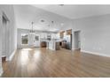 Bright, open-concept living space with modern wood flooring and a view into the stylish, updated kitchen at 2840 Sw 166 Th Ln, Ocala, FL 34473