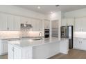 Spacious kitchen with white cabinetry, stainless steel appliances, and a large center island at 8734 Sw 55Th Street Rd, Ocala, FL 34481