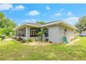 A lovely backyard with a screened in porch, landscaped area, and plenty of room for outdoor enjoyment at 1007 Cr 463B, Lake Panasoffkee, FL 33538