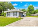 Exterior view of the home featuring an attached garage, neat landscaping, and a well-maintained concrete driveway at 1007 Cr 463B, Lake Panasoffkee, FL 33538