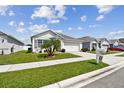 Lovely single-story home with lush green lawn, beautiful landscaping and an attached two-car garage at 879 Killarney Ln, Auburndale, FL 33823