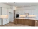 Bright kitchen with white cabinetry, a central island, and a decorative backsplash at 8980 Sw 52Nd Place Rd, Ocala, FL 34481