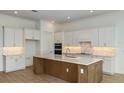 Modern kitchen featuring white cabinets, an island with a sink, and stainless steel appliances at 8980 Sw 52Nd Place Rd, Ocala, FL 34481