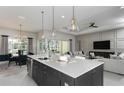 Open-concept kitchen with a large center island, pendant lights, and a view of the living area at 8980 Sw 52Nd Place Rd, Ocala, FL 34481