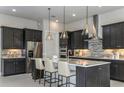 Modern kitchen with a center island, stylish pendant lights, and stainless steel appliances at 8980 Sw 52Nd Place Rd, Ocala, FL 34481
