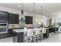 Modern kitchen with a center island, stylish pendant lights, and stainless steel appliances at 8980 Sw 52Nd Place Rd, Ocala, FL 34481