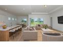 Bright living room featuring an open floor plan, modern furniture, and sliding glass doors to the backyard at 8980 Sw 52Nd Place Rd, Ocala, FL 34481