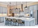 Well-appointed kitchen with an island, stainless appliances, pendant lights, and modern backsplash design at 9245 Sw 52Nd Place Rd, Ocala, FL 34481