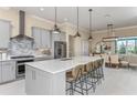 Well-appointed kitchen with an island, stainless appliances, pendant lights, and modern backsplash design at 9245 Sw 52Nd Place Rd, Ocala, FL 34481