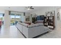 Stylish living room with a large sliding glass door leading to a backyard view and cozy furnishings at 4779 Waltham Forest Dr, Davenport, FL 33837