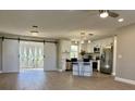 Open-concept kitchen with stainless steel appliances, an island with seating, and stylish barn doors at 620 San Pedro Dr, Lady Lake, FL 32159