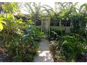 Charming home entrance framed by lush greenery, featuring a welcoming walkway and vibrant flowers at 109 Fern Dr, Debary, FL 32713