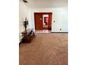 View of the living room, with carpet and access to other areas of the home at 1527 E Elm Rd, Lakeland, FL 33801