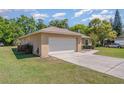 Side view of a one-story home with a two-car garage, long driveway, and a tidy, green lawn at 4530 Old Road 37, Lakeland, FL 33813