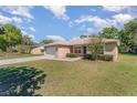 Well-kept one story home featuring manicured bushes, lush green grass, and an attached garage at 4530 Old Road 37, Lakeland, FL 33813