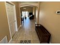 Open hallway with neutral tile flooring leading to living area at 1124 Liberty Hall Dr, Kissimmee, FL 34746