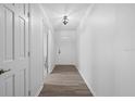 Bright hallway with wood-look floors leading to other rooms in the home at 1203 Lake Miriam Dr, Lakeland, FL 33813