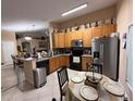 Well-equipped kitchen with black appliances, wooden cabinets, and tiled backsplash at 3112 Antietam Creek Ct, Orlando, FL 32837