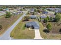 Aerial view of a home with a two-car garage, long driveway and expansive lawn at 13581 Sw 48Th Ct, Ocala, FL 34473