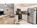 Modern kitchen with granite countertops and stainless steel appliances at 13581 Sw 48Th Ct, Ocala, FL 34473