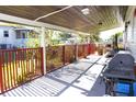 Relaxing outdoor living space with barbecue, swing and potted plants along the porch rail at 2514 Sea Oats N Cir, Lakeland, FL 33815