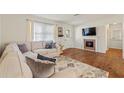 Bright living room with a fireplace, wood floors, large sofa, and natural light at 2971 Gardenia Dr, Indian Lake Estates, FL 33855