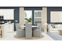 Cozy dining area featuring a round table, comfortable seating, and natural light from the nearby windows at 4578 Ochos Rios Pl, Kissimmee, FL 34758