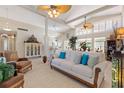 Bright living room with high ceilings, ceiling fans, and neutral tones create an open and inviting space at 6365 Avocado Dr, Indian Lake Estates, FL 33855