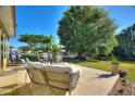 Inviting outdoor patio with comfortable seating, perfect for relaxing and enjoying the serene waterfront view at 6365 Avocado Dr, Indian Lake Estates, FL 33855