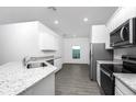 Well-lit kitchen with stainless appliances, granite counters and ample storage at 13279 Tula Loop, Astatula, FL 34705