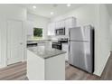 Bright kitchen with stainless steel appliances, granite countertops, and an island at 13283 Tula Loop, Astatula, FL 34705
