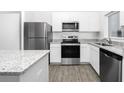 Well-equipped kitchen with granite countertops and stainless steel appliances at 13283 Tula Loop, Astatula, FL 34705