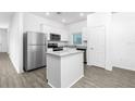Modern kitchen with stainless steel appliances and a granite countertop island at 13283 Tula Loop, Astatula, FL 34705