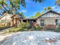 Well-kept home featuring brick accents, neutral exterior, and a spacious driveway in a serene setting at 1905 Seminole Trl, Lakeland, FL 33803