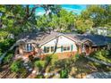 Charming single-story home boasts lush landscaping, inviting curb appeal, and classic architectural details at 1905 Seminole Trl, Lakeland, FL 33803