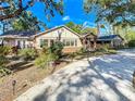 Lovely single-Gathering home showcases a well-maintained lawn, mature trees, and a welcoming entrance at 1905 Seminole Trl, Lakeland, FL 33803
