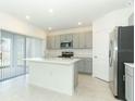 Bright kitchen featuring stainless steel appliances, modern cabinetry, and a large center island at 2430 Slippery Rock St, Auburndale, FL 33823
