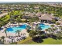 Aerial view of a community pool and clubhouse surrounded by manicured grounds at 8983 Azalea Sands Ln # 8983, Davenport, FL 33896