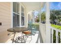 Cozy front porch featuring a quaint seating area, perfect for relaxing and enjoying the neighborhood views at 1002 Periwinkle Ct, Celebration, FL 34747