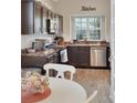 Well-equipped kitchen featuring stainless steel appliances and dark cabinetry at 1802 Royal Ridge Dr, Davenport, FL 33896