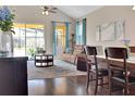 Inviting living room with hardwood floors, stylish furnishings, and natural light overlooking the pool at 1802 Royal Ridge Dr, Davenport, FL 33896