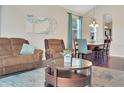 Comfortable living room featuring stylish furnishings and a view of the dining area at 1802 Royal Ridge Dr, Davenport, FL 33896