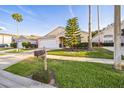 Lovely single-Gathering home with a lush lawn, a mailbox, and mature trees in a serene neighborhood at 319 Bailey Cir, Davenport, FL 33897
