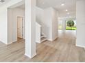 Bright foyer with elegant wood-look floors, neutral paint, and an open floor plan leading to the living areas at 5932 Bristle Oak St, Mount Dora, FL 32757